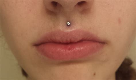 lip piercing small|piercing above top lip.